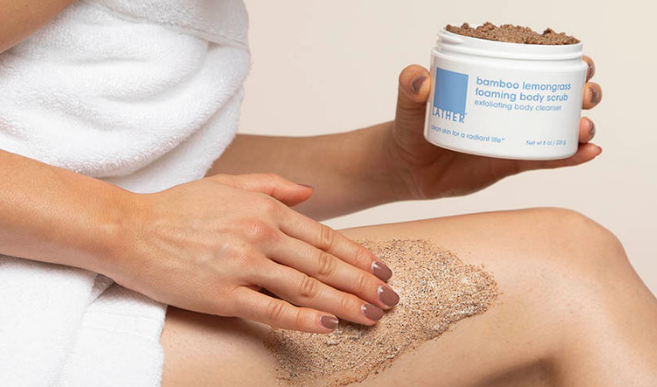 Woman applying Bamboo Lemongrass Body Scrub to thigh