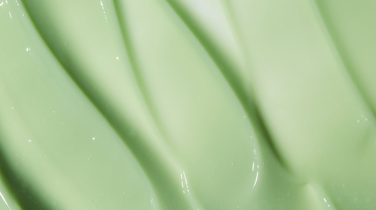 Close up of light green LATHER conditioner product, emphasizing rich creamy texture.