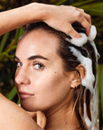 Woman with soap bubbles in her hair.