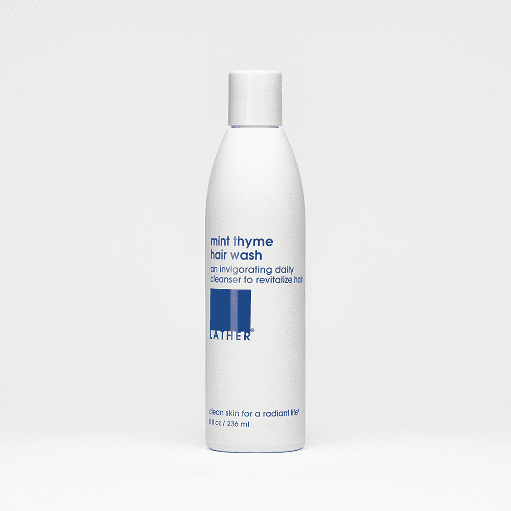 White bottle of hair wash on white background.