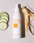 Cucumber and Ginseng Facial Mist bottle next to slices of cucumber and a raw ginseng root